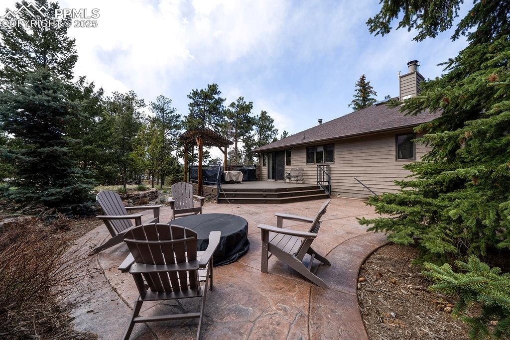 Image 38 of 42: View of patio / terrace featuring an outdoor fire pit and a deck