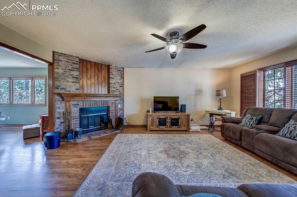 Image 8 of 42: Living area featuring plenty of natural light, a ceiling fan, and a texture