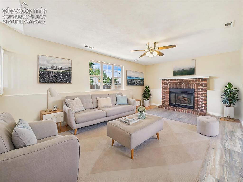 Image 21 of 50: (Virtually Staged) Spacious lower-level family room featuring a charming br
