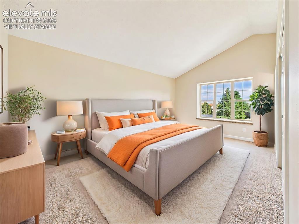 Image 25 of 50: (Virtually Staged) Spacious primary suite with vaulted ceilings, plush carp