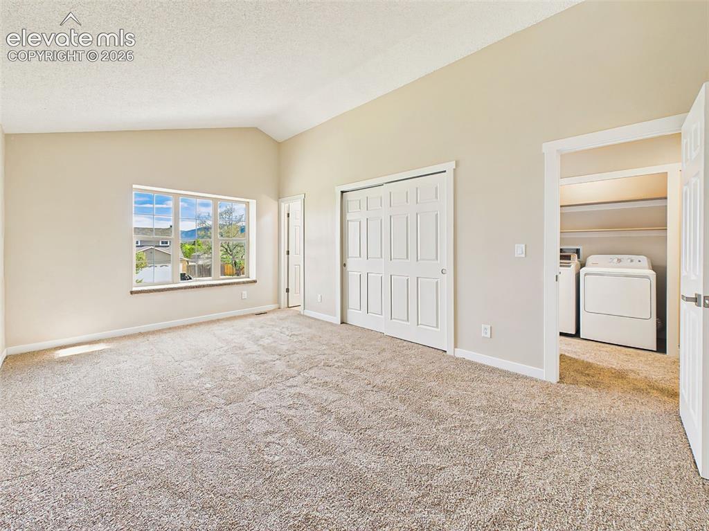 Image 26 of 50: Large primary suite with vaulted ceilings, dual closets, new carpet, oversi