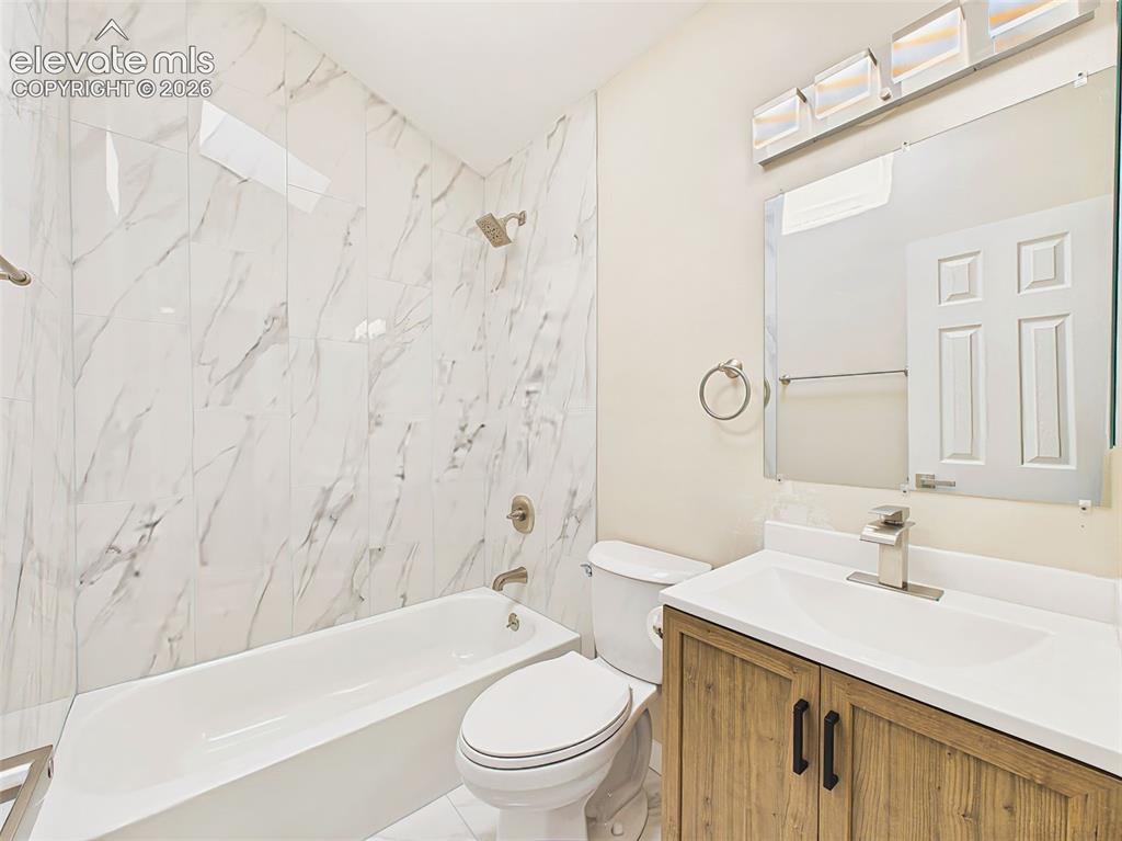 Image 36 of 50: Recently renovated full bathroom with skylight, designer tile surround, upd