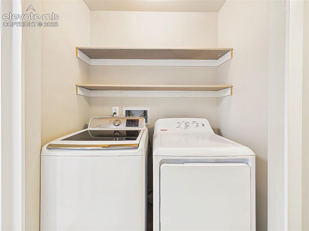 Image 37 of 50: Convenient upstairs laundry space featuring a modern washer and dryer, buil