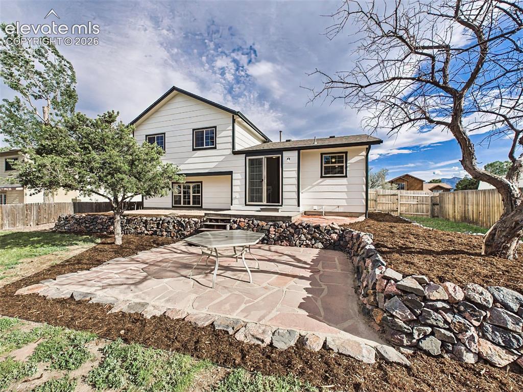 Image 38 of 50: Step outside to a beautifully designed backyard oasis showcasing a large fl