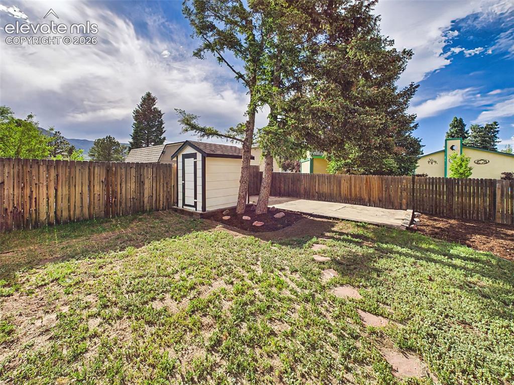 Image 43 of 50: Large fenced backyard with storage shed, RV parking potential, outdoor stor