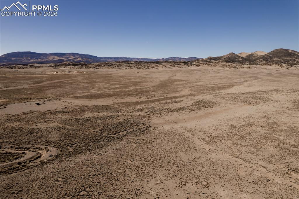 Image 10 of 16: View of mountain background featuring a desert landscape