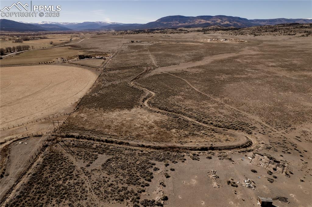 Image 13 of 16: Overview of rural landscape with a desert landscape and a mountain backdrop