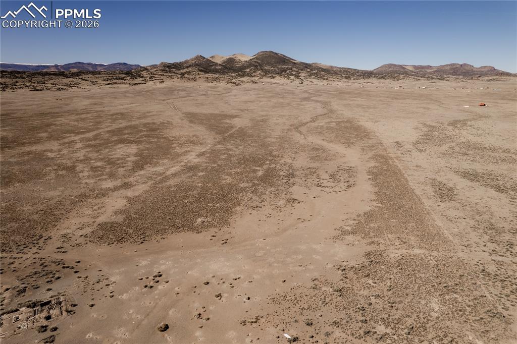 Image 14 of 16: View of mountain background with a desert landscape and rural landscape