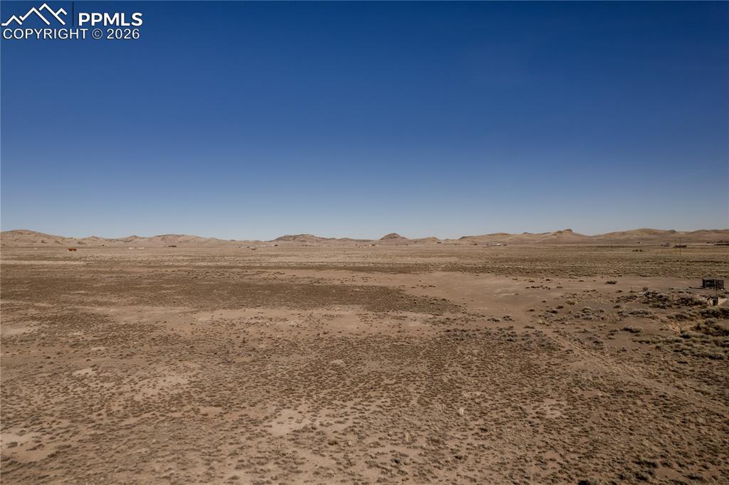 Image 2 of 16: View of nature with a mountain backdrop and a desert landscape