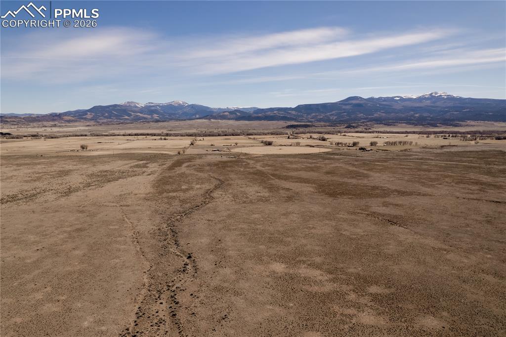 Image 4 of 16: View of mountain backdrop with rural landscape and a desert landscape