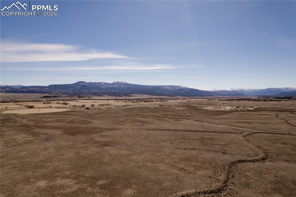 Image 5 of 16: View of mountain backdrop with rural landscape and a desert landscape