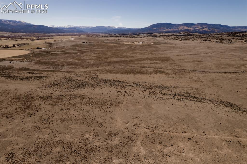 Image 7 of 16: View of mountain backdrop with a desert landscape and rural landscape