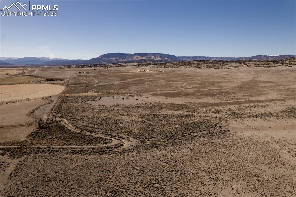 Image 9 of 16: View of mountain background with rural landscape and a desert landscape