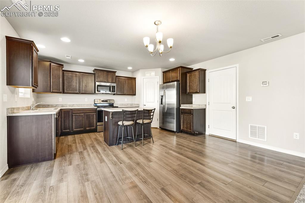 Image 10 of 38: Kitchen and dining