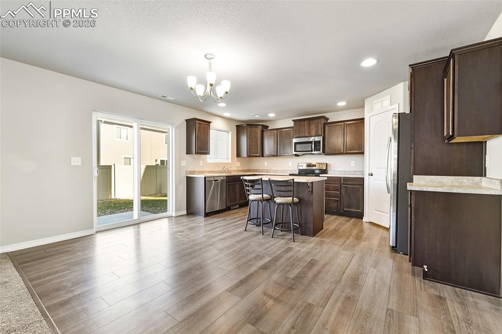 Image 9 of 38: Kitchen and dining with walk out to patio