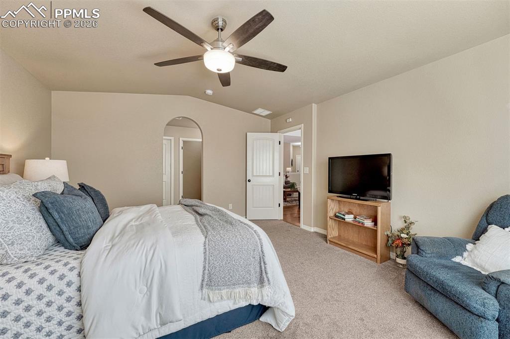 Image 10 of 41: Main-level primary suite with walk-in closet and private bath.