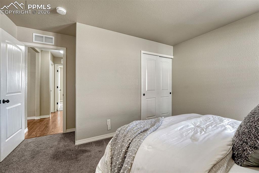 Image 15 of 41: Spacious secondary bedroom with plenty of natural light and flexible layout