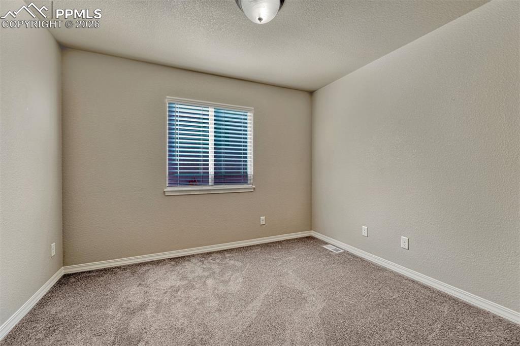 Image 19 of 41: Flexible space for rest, work, or play — additional bedroom on the main lev