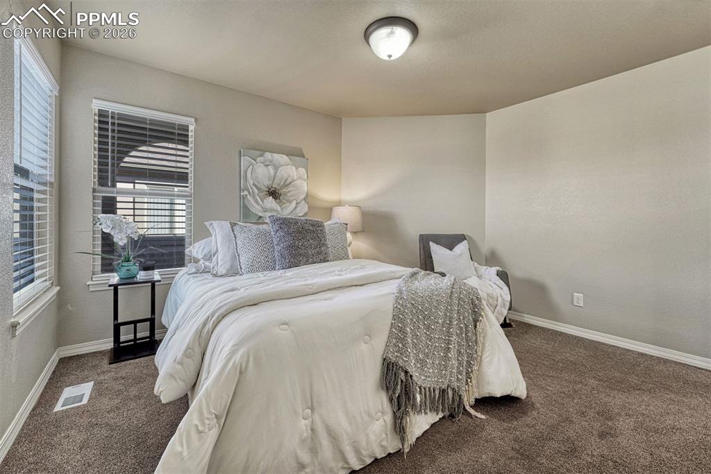 Image 20 of 41: Cozy and well-lit bedroom with easy access to a full bath.