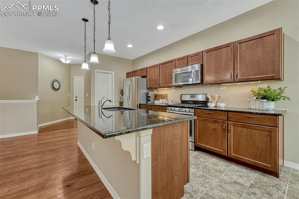Image 28 of 41: Functional and stylish — granite counters, stainless appliances, and a gene