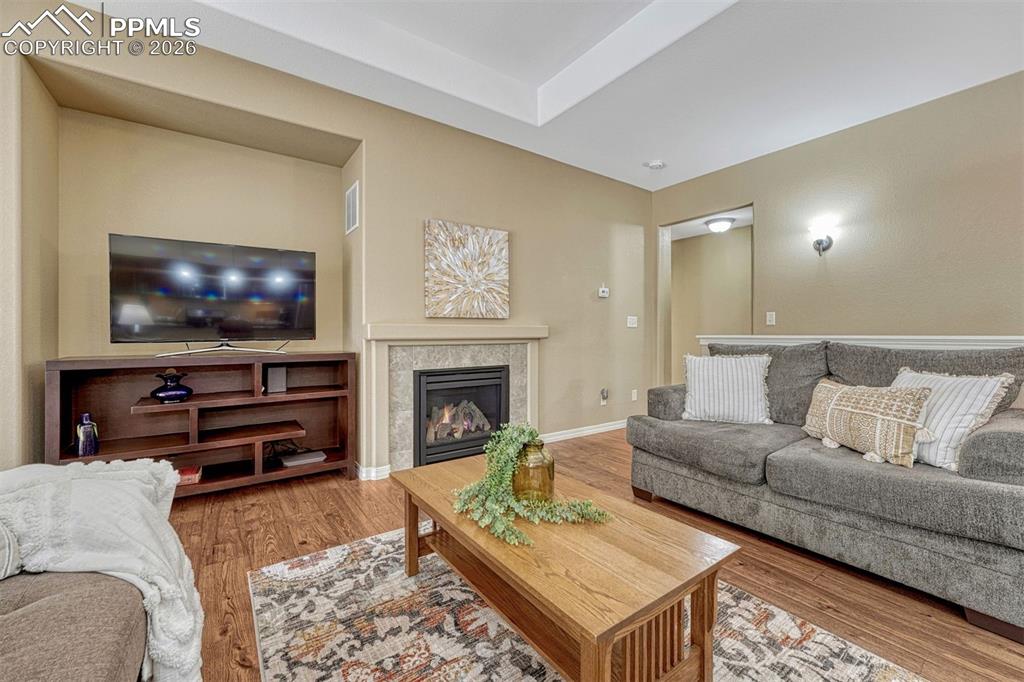 Image 31 of 41: Open and inviting living space featuring a gas fireplace, trey ceiling, and