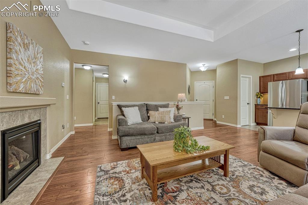 Image 35 of 41: Comfort meets style — gas fireplace, trey ceiling, and luxury vinyl plank f