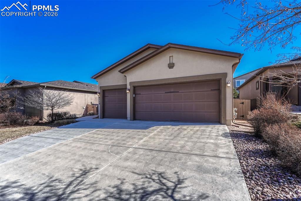 Image 37 of 41: More time to enjoy, less time maintaining — insulated 3 car garage and HOA