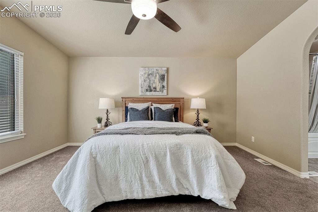 Image 7 of 41: Wake up in comfort — bright, serene primary bedroom with generous walk-in c