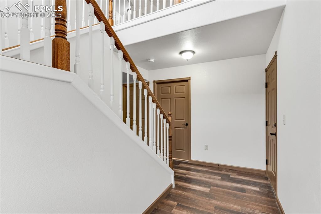 Image 6 of 50: Entrance foyer featuring wood finished floors and stairs