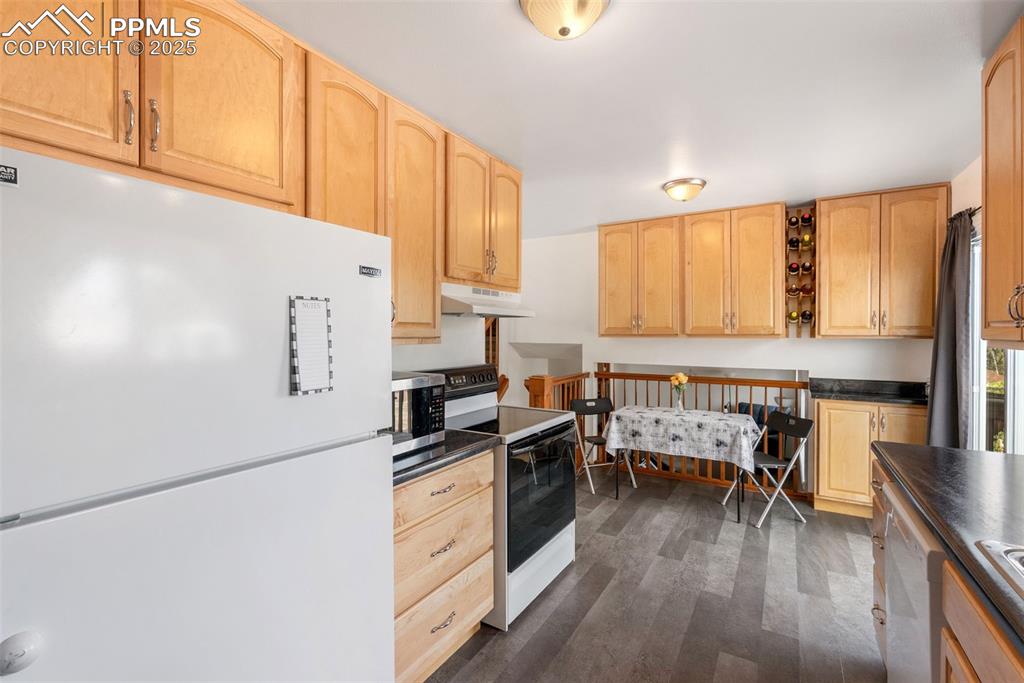 Image 12 of 42: Kitchen comes with refrigerator, glass top electric range oven with vent fa