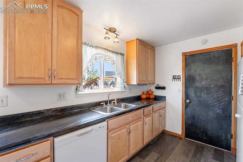 Image 14 of 42: The kitchen counters are a dark marble looking laminate for added character