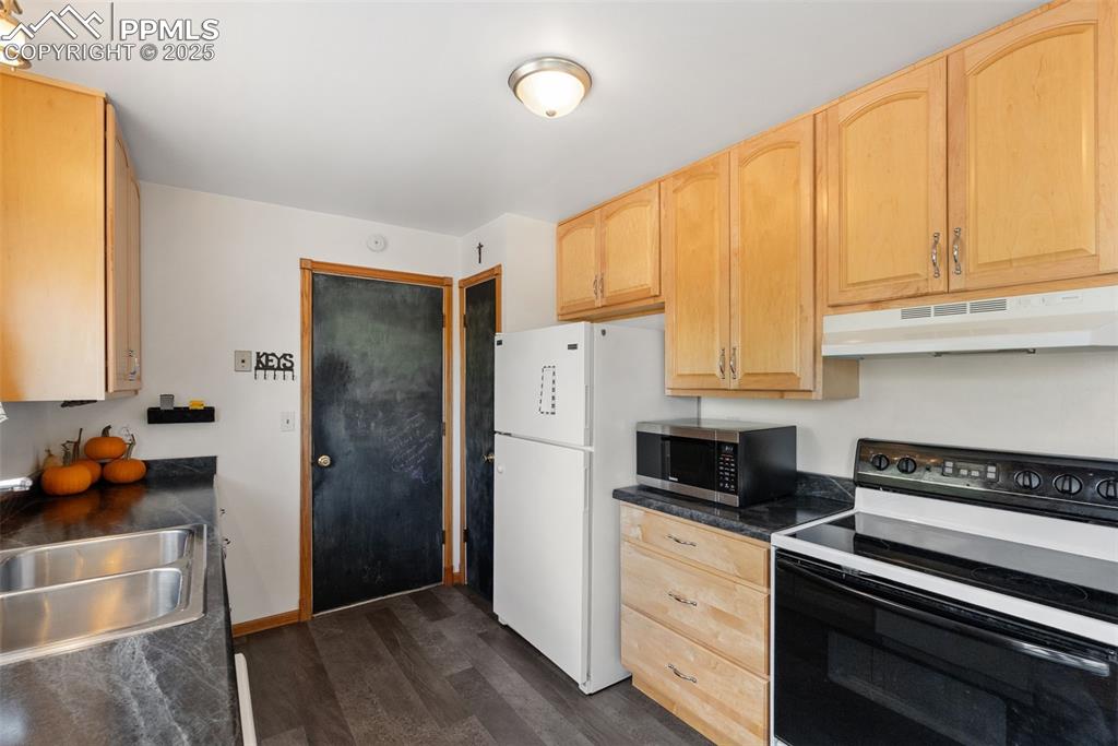 Image 15 of 42: The other side of the kitchen gives you access to the garage with your own