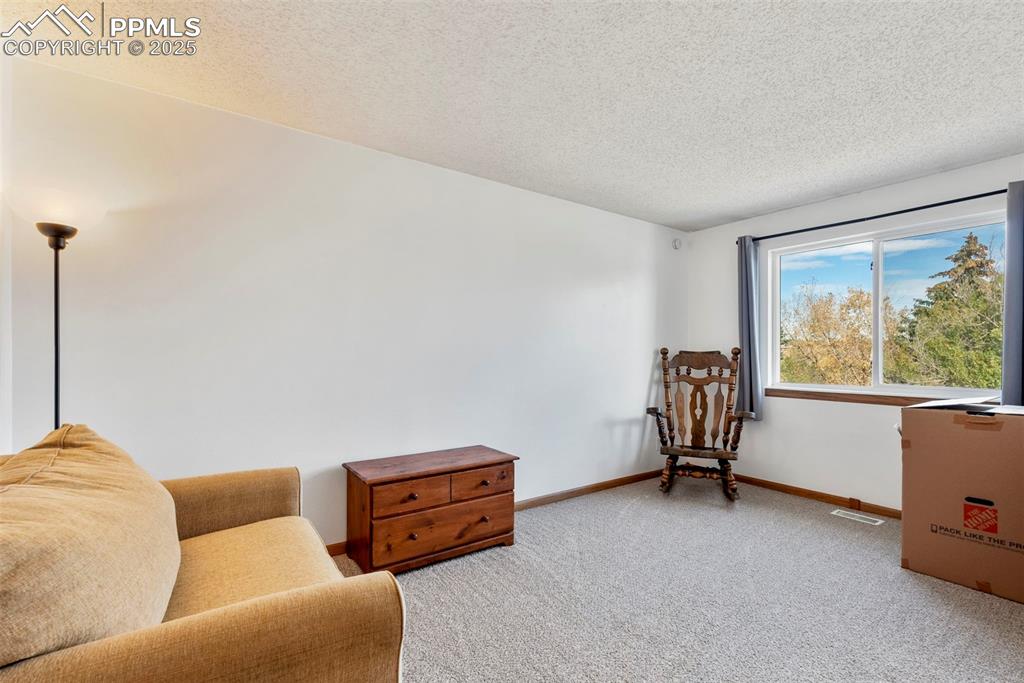Image 22 of 42: Good sized bedroom with a large window