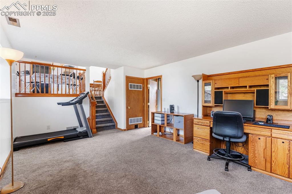 Image 27 of 42: Head down to the lower level family room which offers great space for enter