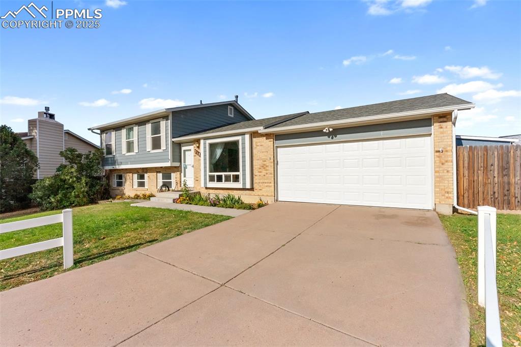 Image 3 of 42: The large front window fills the living room with light. Park your vehicle