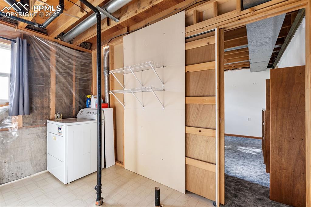 Image 35 of 42: Lower level utility and laundry space with room for storage.