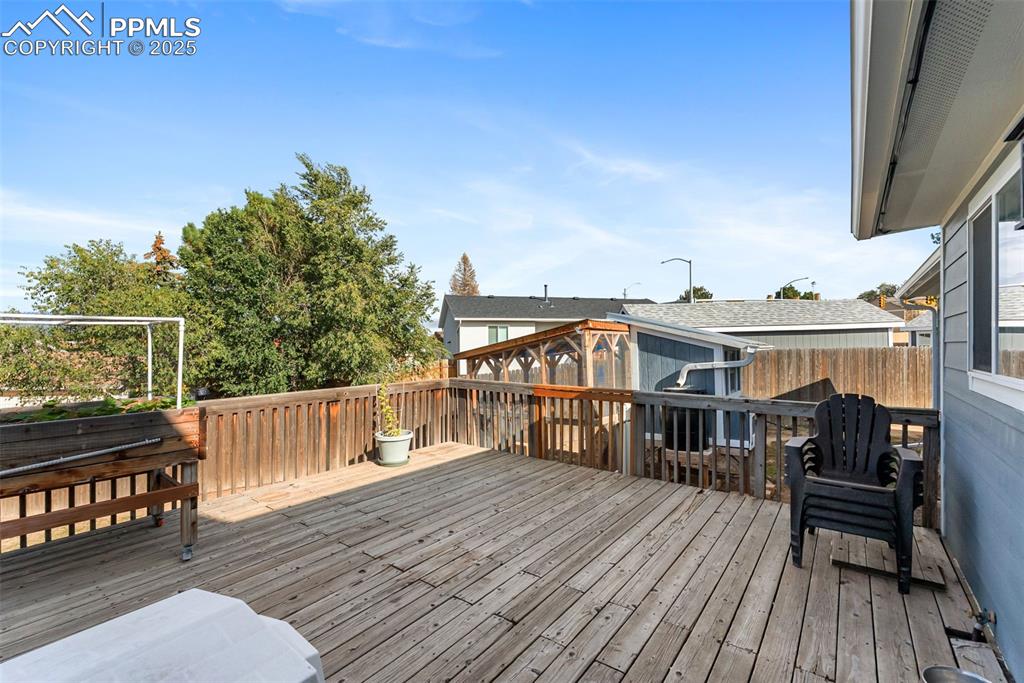 Image 36 of 42: Lets venture out back to the large wood deck where you can relax or enterta