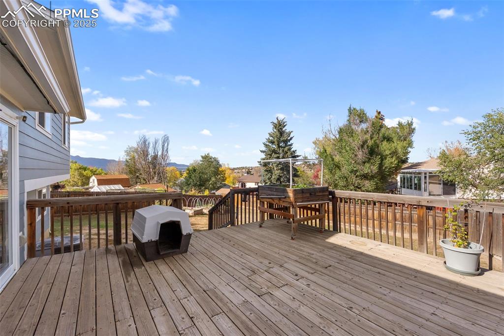 Image 37 of 42: With the mountain views the backyard and deck are true outdoor living space