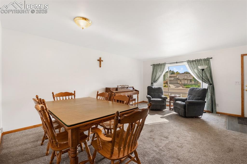 Image 6 of 42: The large window fills the home with light and the warm Colorado sun