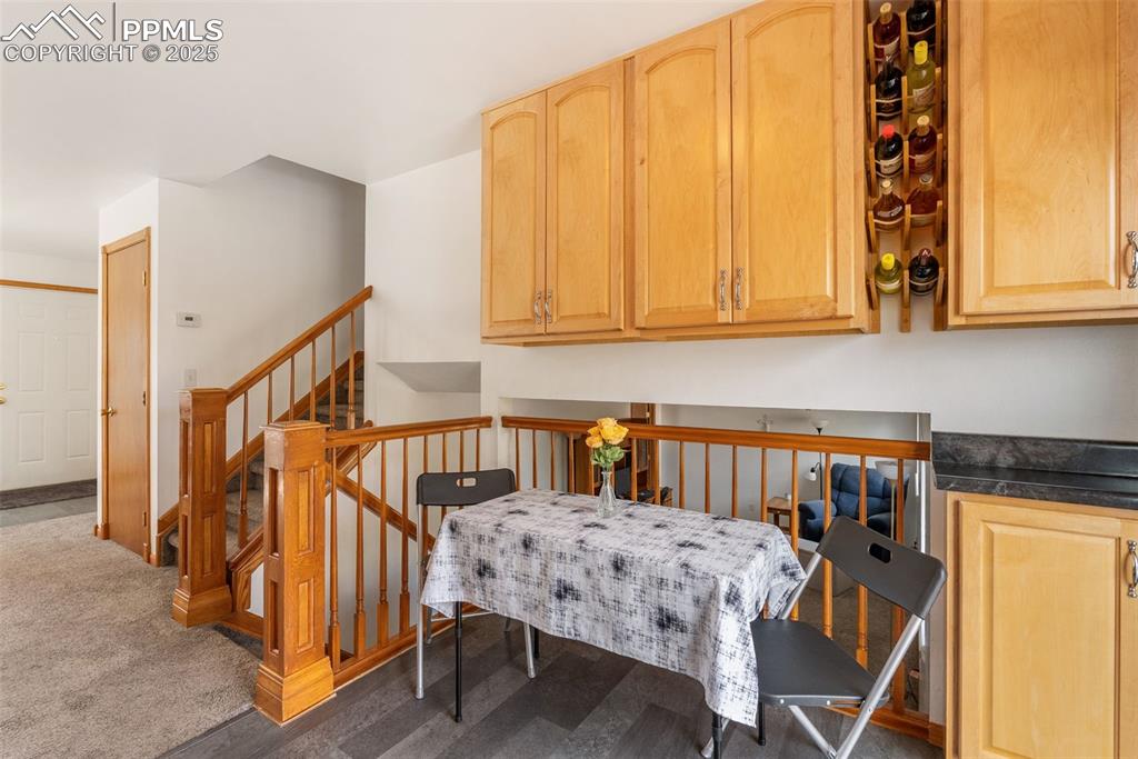 Image 9 of 42: The kitchen and dining space feature luxury vinyl flooring and extra upper