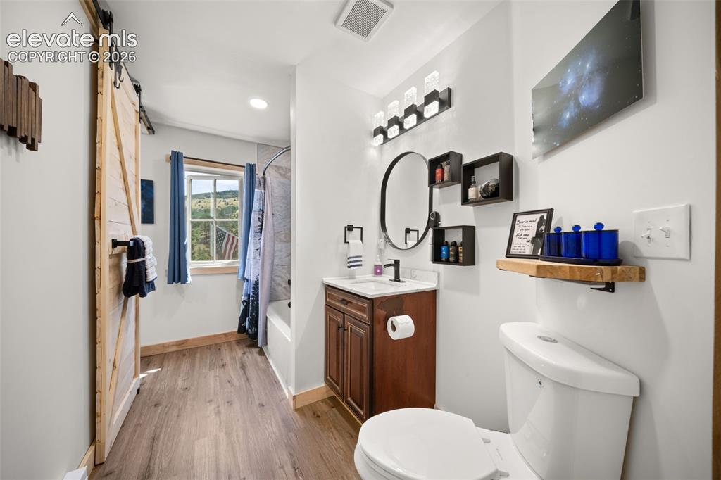 Image 18 of 42: Main leve full bathroom connected to primary and access for guests