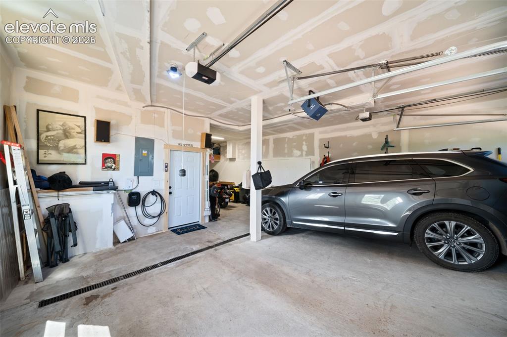 Image 26 of 42: 3 car attached heated tandem garage