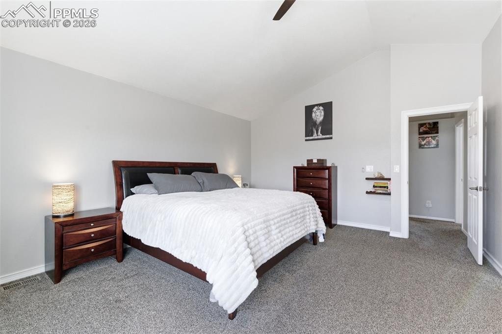 Image 17 of 44: Vaulted ceiling and ceiling fan really keep this primary bedroom open and l