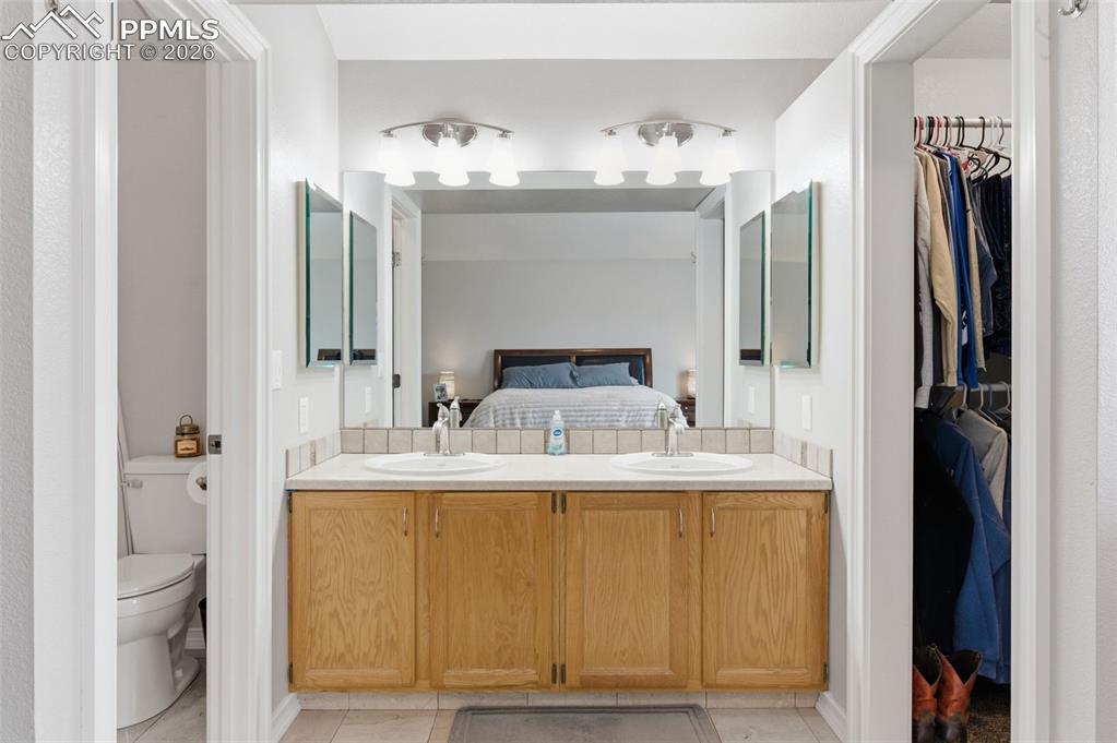 Image 20 of 44: Primary bath offers double vanity; spacious walk-in closet; and private bat