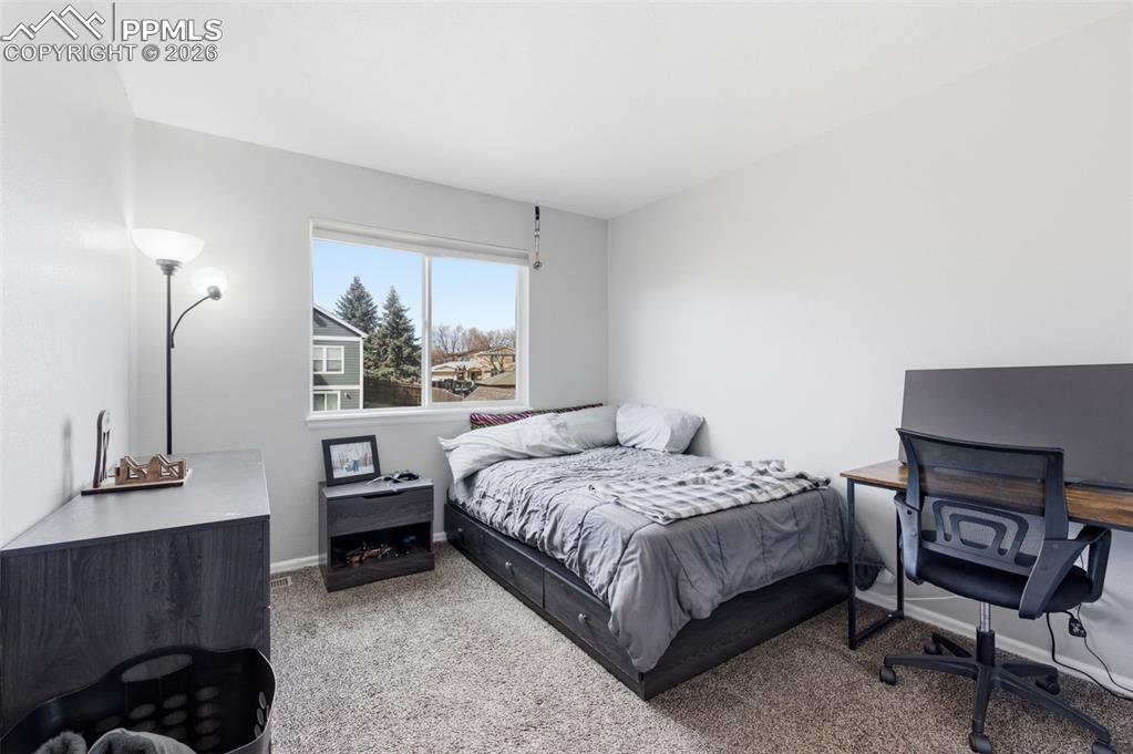 Image 24 of 44: This secondary bedroom is spacious and bright