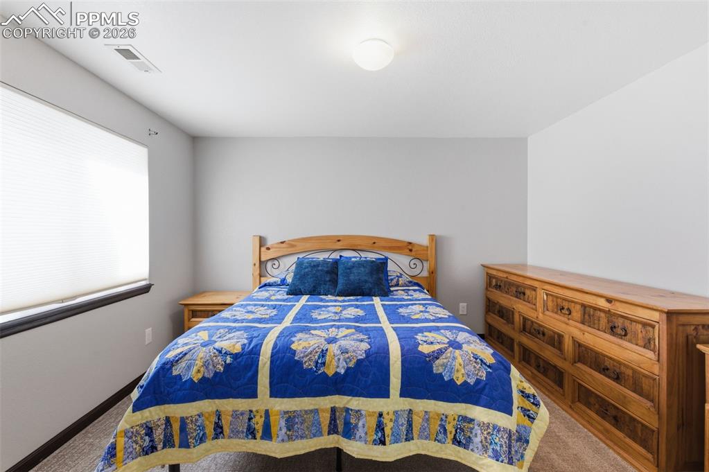 Image 33 of 44: Lower level bedroom is light and bright.