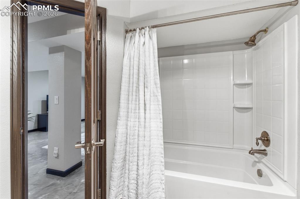 Image 35 of 44: Lower level full bath serves the rec room activity as well as the bedroom o