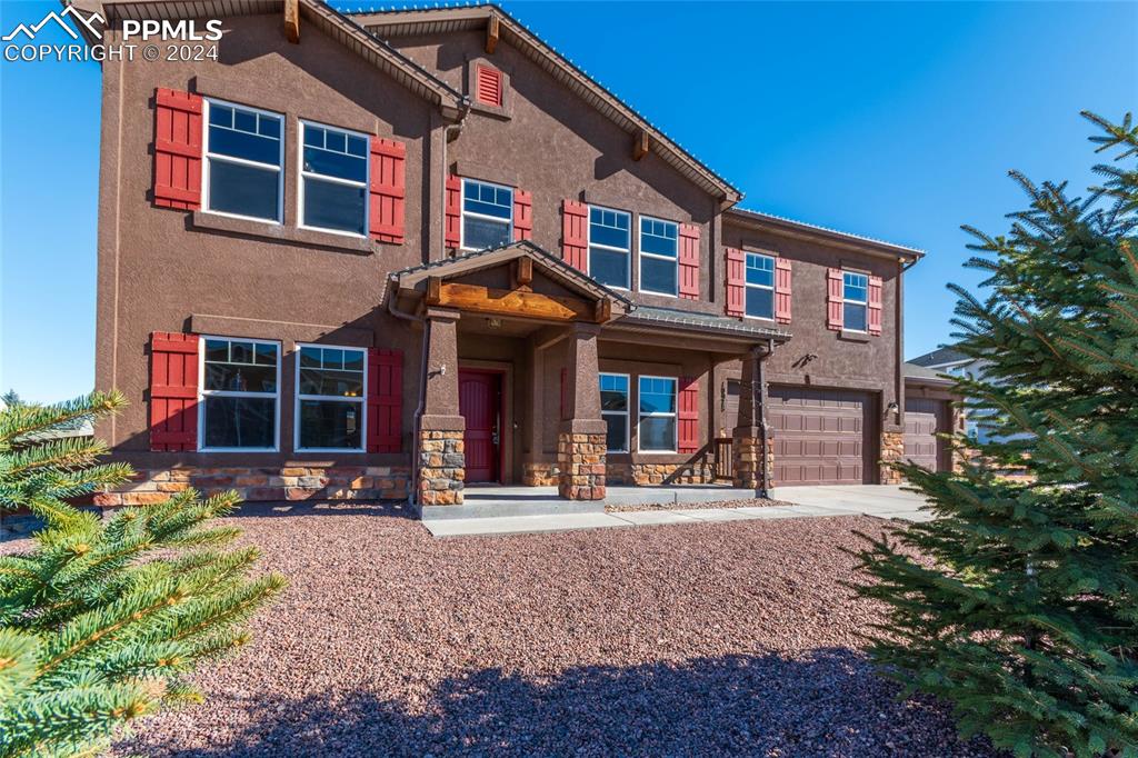 Image 4 of 41: View of front of home with a garage