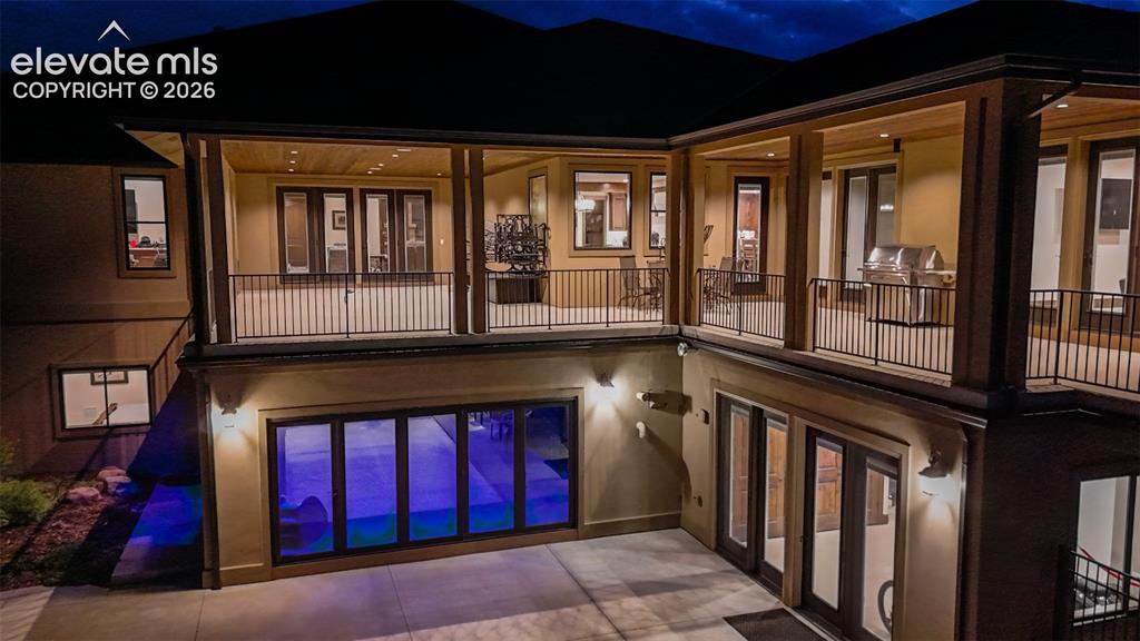 Image 2 of 50: Multi-level outdoor living spaces featuring covered patios and balconies wi