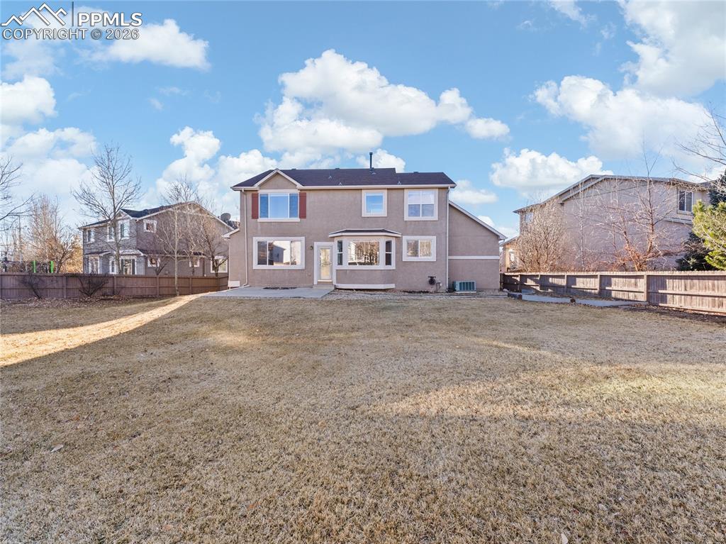 Image 4 of 46: Back of property featuring a fenced backyard and a patio area